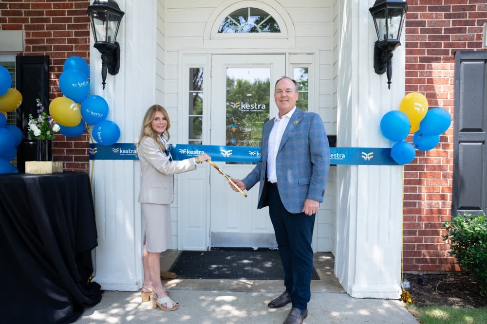 Kestra Chief Administrative Officer and general counsel Traci Umberger, left, and President and CEO Brian Webster participate in a ribbon cutting at the company's Southlake office July 30.