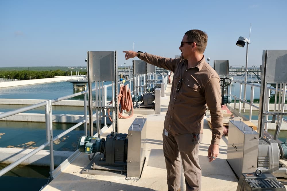 A city of Georgetown Water Utility employee explains the water filtration steps in the new water treatment facility. (Gracie Warhurst/Community Impact)