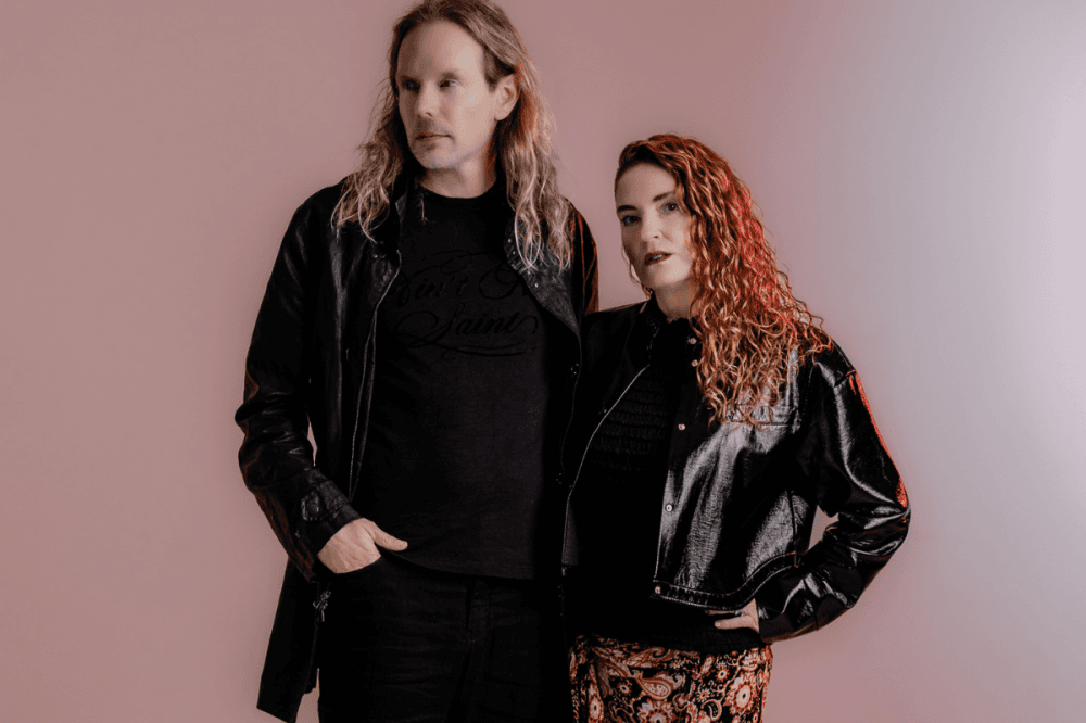 man and woman pose in studio