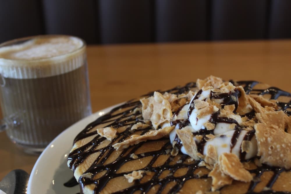 Cannoli pancakes served with a latte.