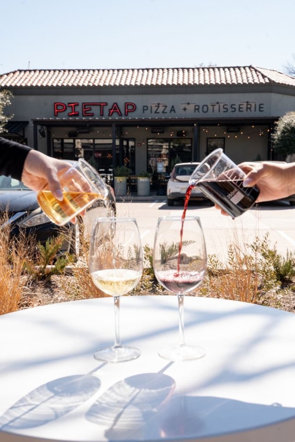 people pouring wine into a glass