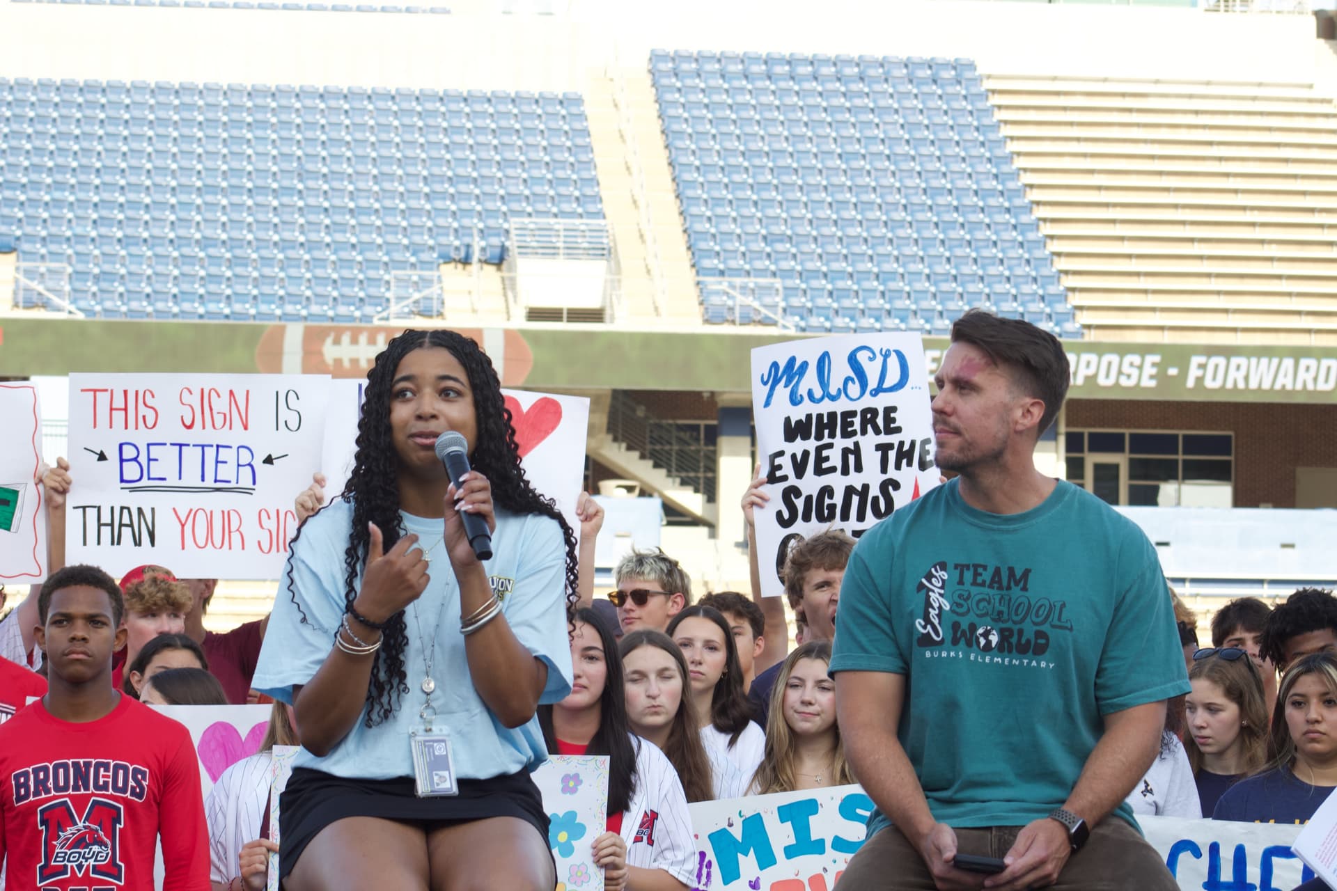 two people speaking on a stage