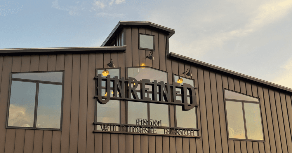Unreined Whiskey, dubbed the official whiskey of Texas A&M Athletics, celebrated the grand opening of its new visitor center and rickhouse Aug. 8 at WildHorse Ranch in College Station. (Karley Cross/Community Impact)