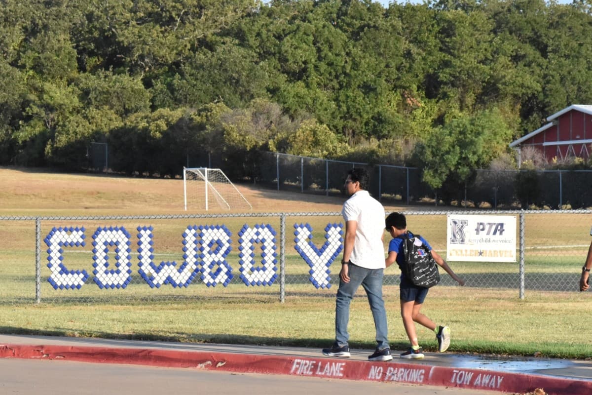 man walking a kid to school