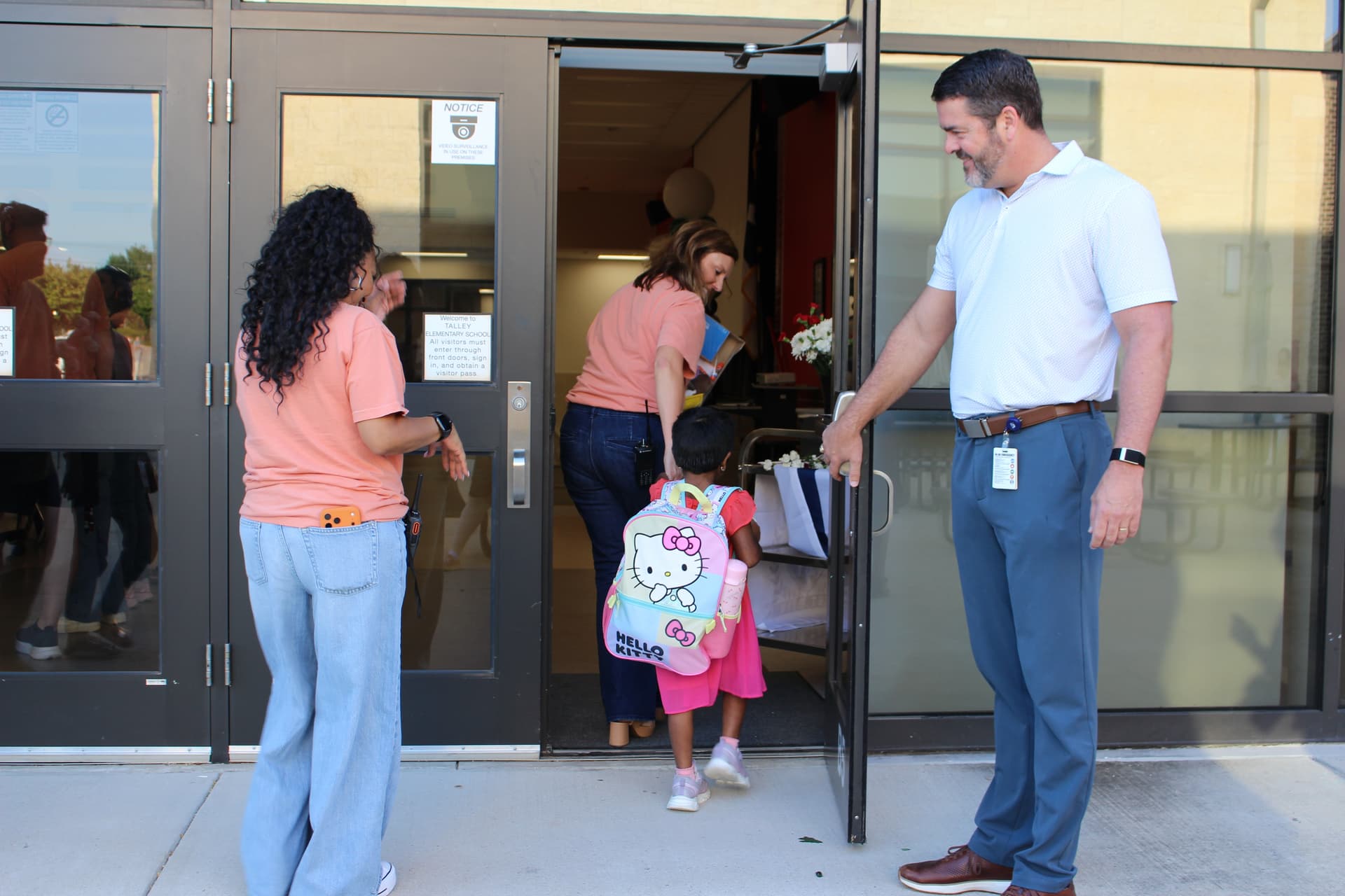 Superintendent Todd Fouche welcomes a student to campus at Talley Elementary School on Aug. 12. (Samantha Douty/Community Impact)