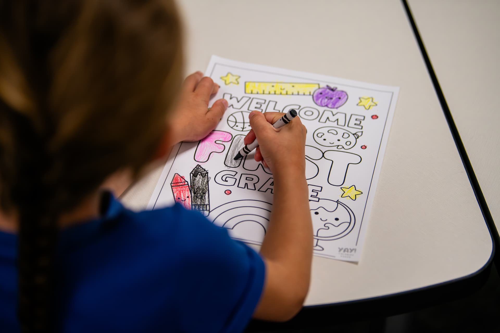 A child colors at Romer Elementary for the first day of school. (Sara Carpenter/Community Impact)