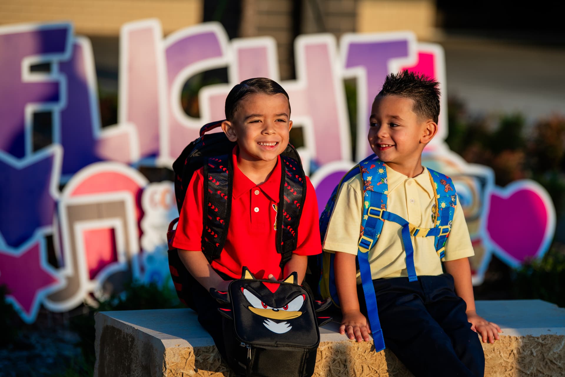 Students smile outside of Romer Elementary before the first day of school began Aug. 12. (Sara Carpenter/Community Impact)