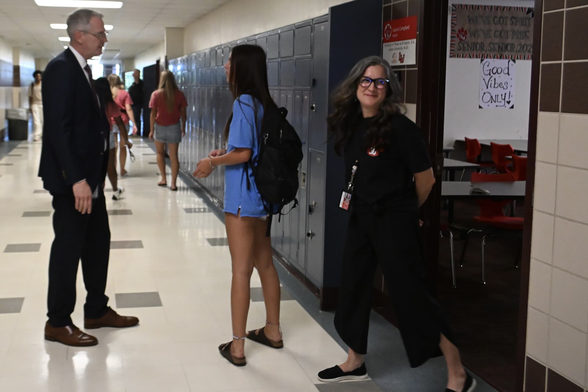 GCISD Superintendent Jason Adams speaks with a student in the halls of Colleyville Heritage High School during the first day of school.