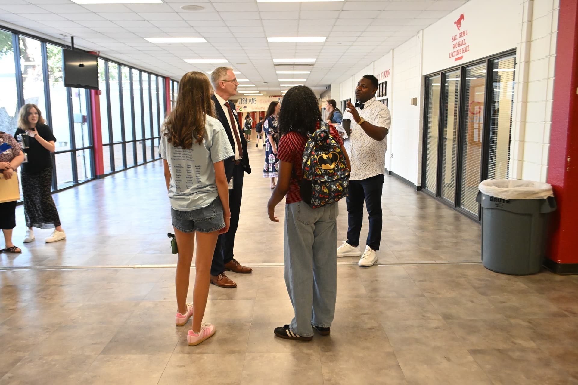 GCISD staff talk with two students during the first day of school at Grapevine High School.