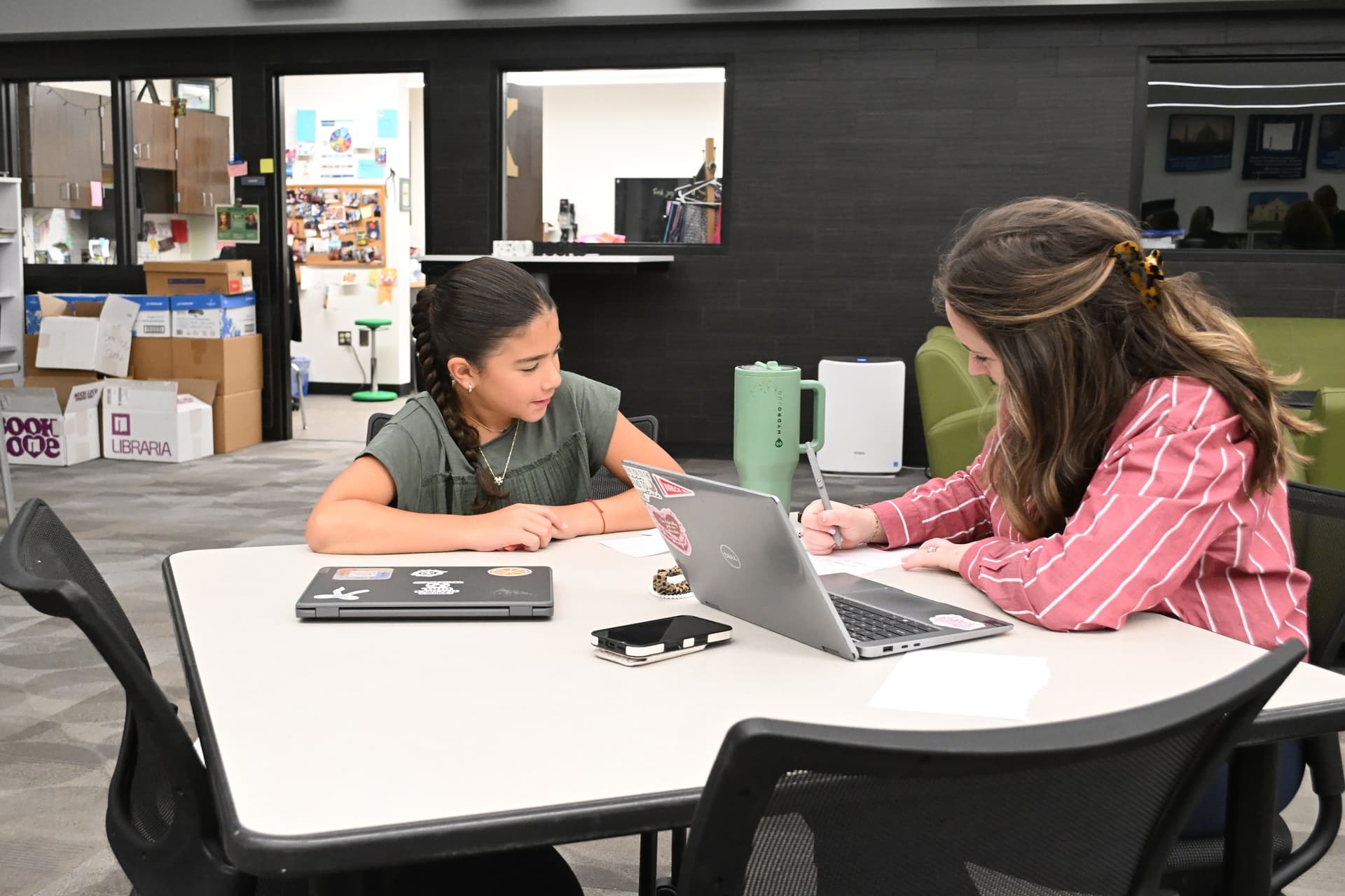 Bailey Gross, right, works with student Bailey Priesand on a schedule at Cross Timbers Middle School.