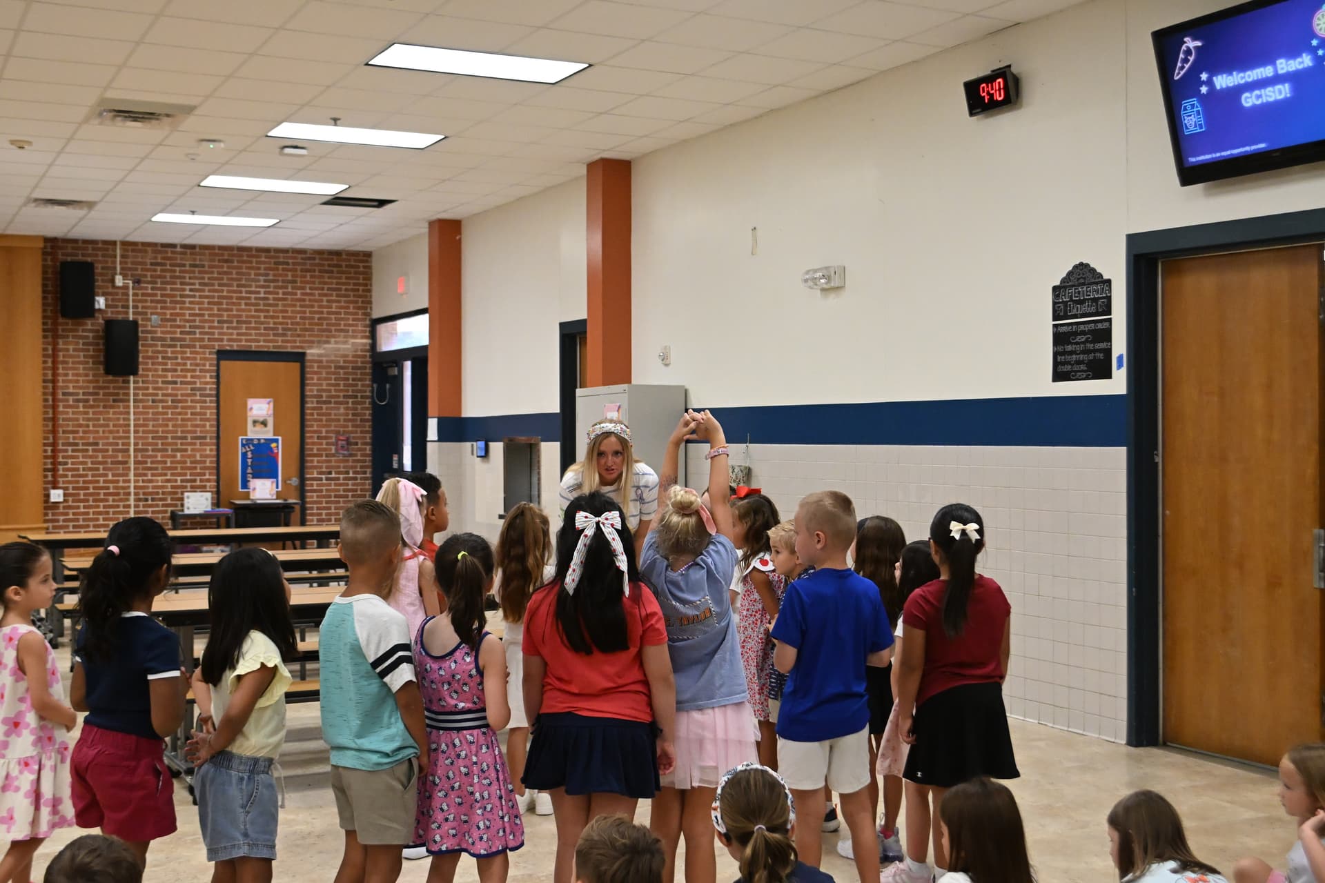 An O.C. Taylor staff member runs through lunchtime procedures with students.