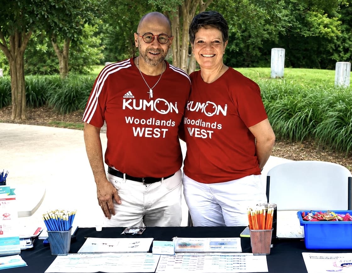 A couple wearing Kumon shirts.