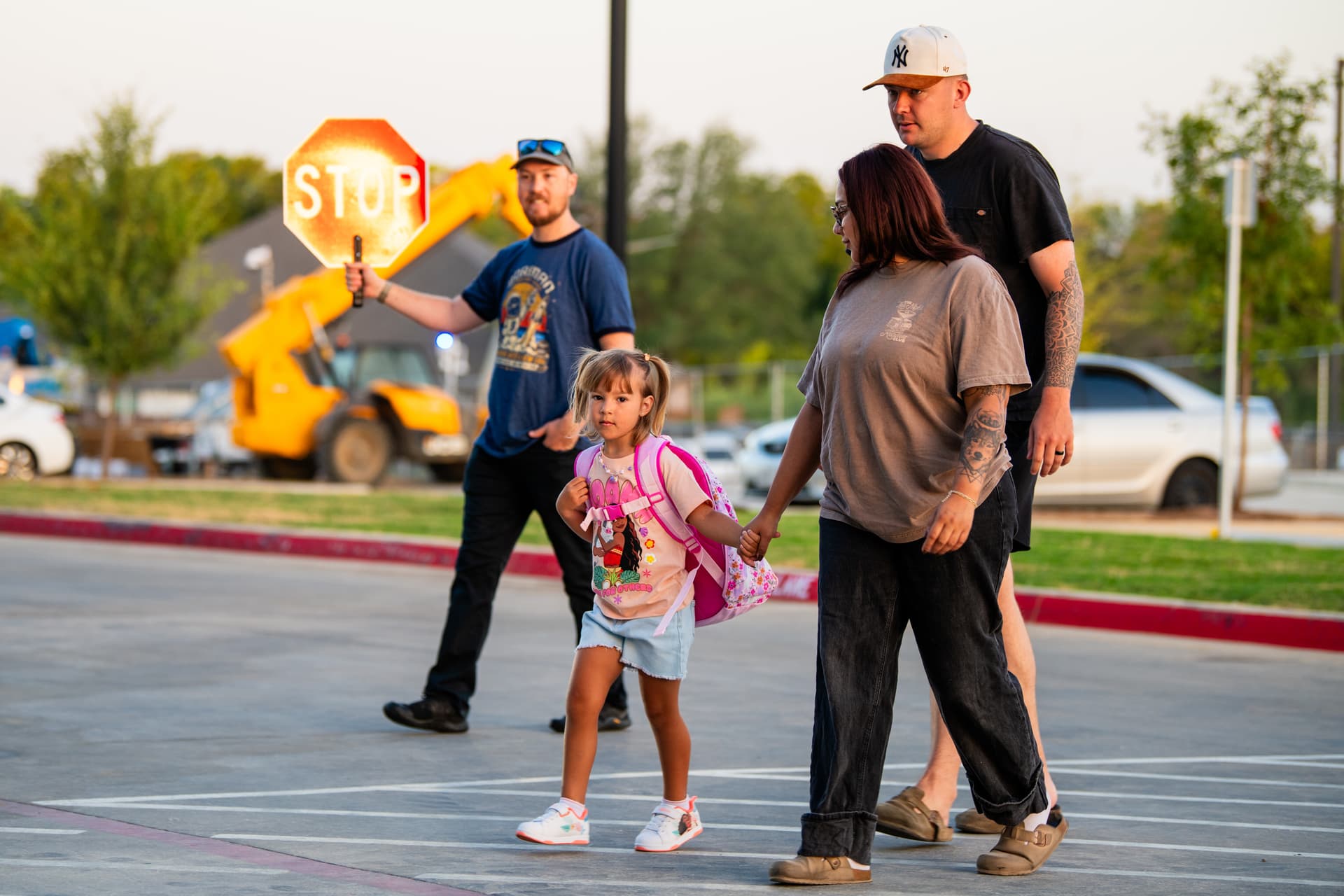 Parents use the crosswalk with their child at Borman Elementary School during the first day of school on Aug. 13. (Sara Carpenter/Community Impact)