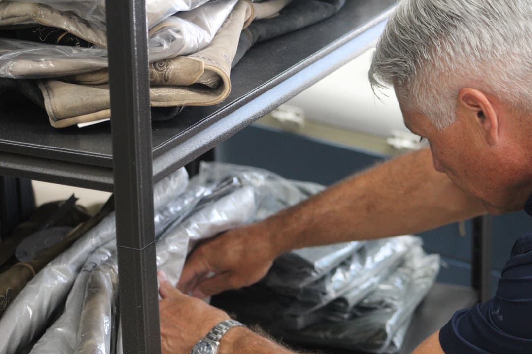 A man shops through the lederhosen options at Fräuleins German Store on Aug. 13, 2026.