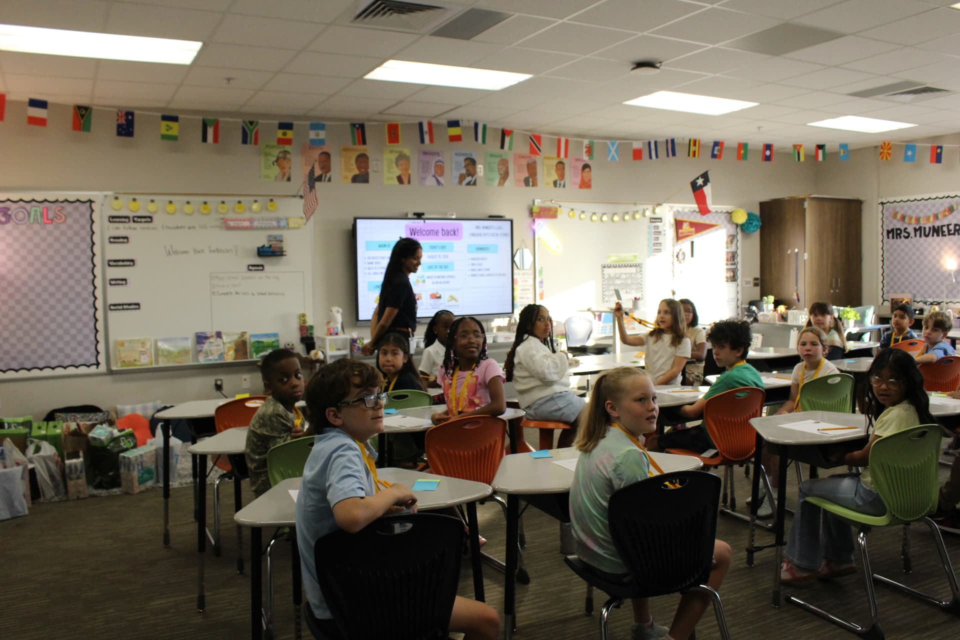 Fourth grade teacher Sana Muneer welcomes students to her classroom on the first day of school. (Brooke Sjoberg/Community Impact)