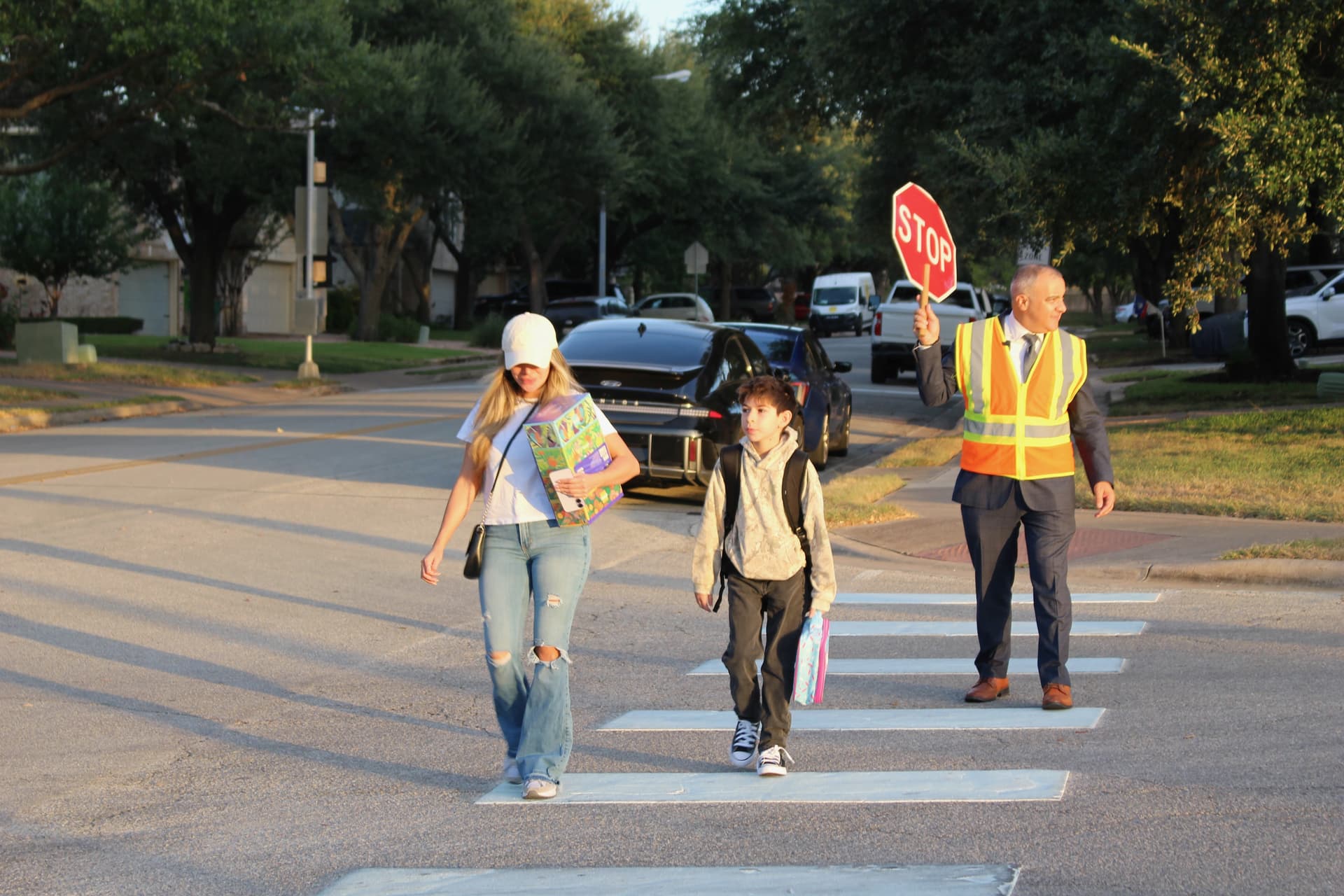 Superintendent Hafedh Azaiez took on crosswalk duties for the first day of school. (Brooke Sjoberg/Community Impact)