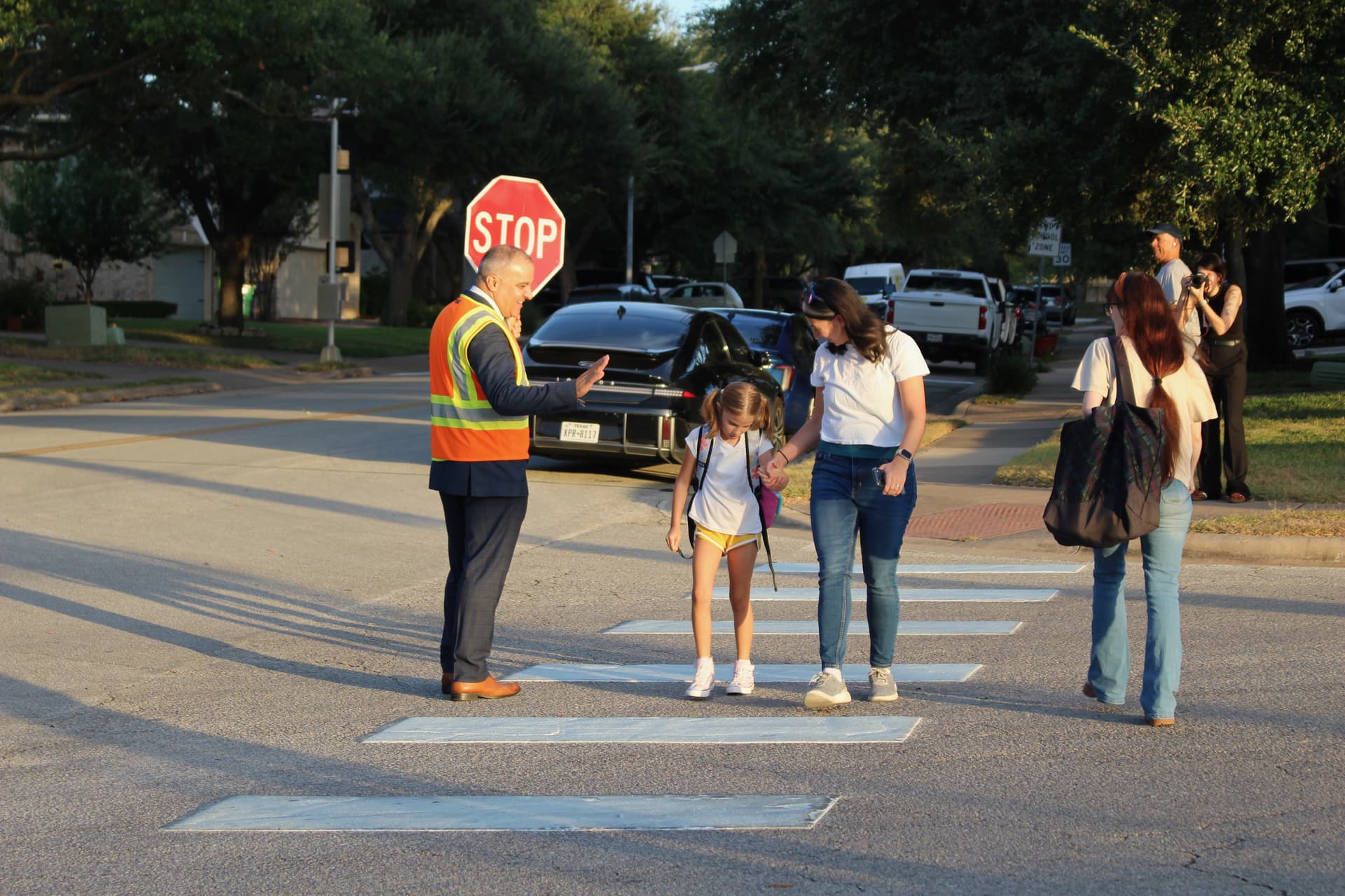 Superintendent Hafedh Azaiez greets students on their way to school. (Brooke Sjoberg/Community Impact)