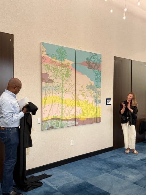 people look at a mural