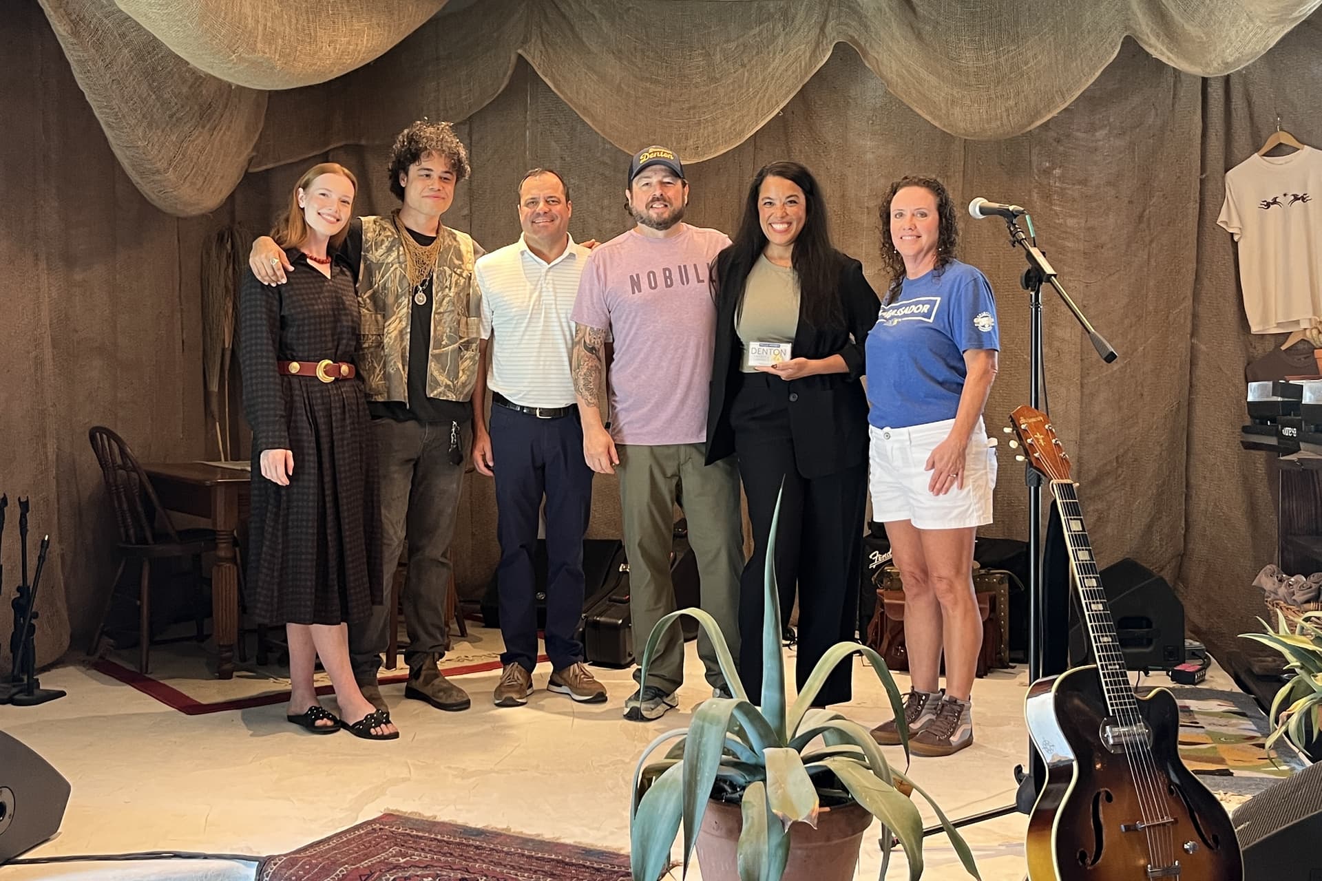 Bella Tylen (far left), Dorian Marsh (second from left), Owen Madsen (third from right) and Jessica Madsen (second from right) received a ceremonial plaque from the Denton Chamber of Commerce Aug. 28. (Gabby Bailey/Community Impact)