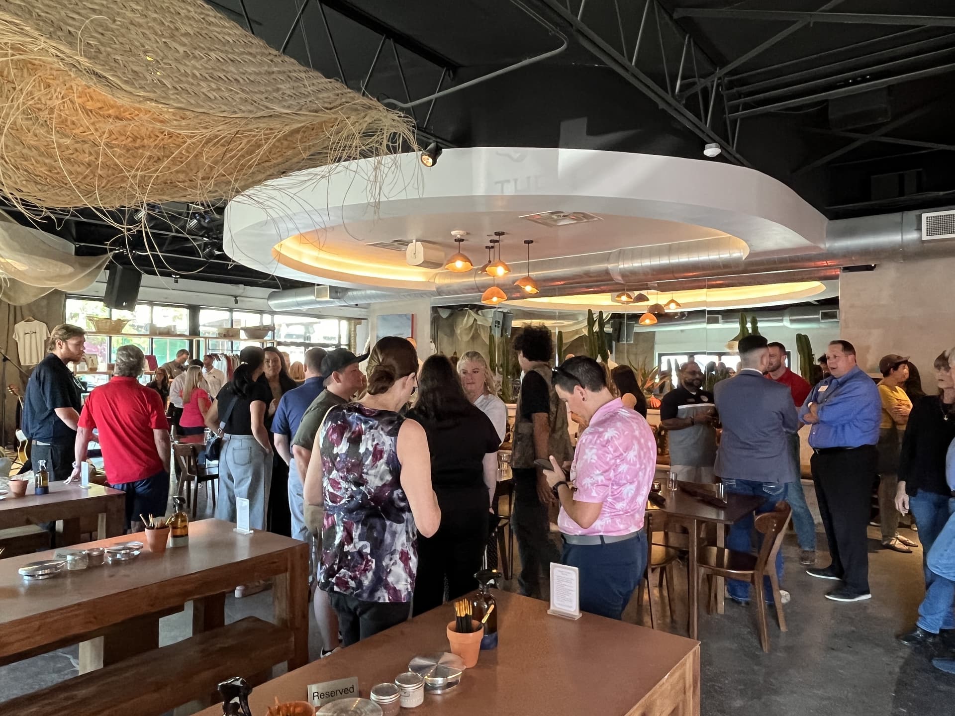 Chamber members and community leaders mingle and sample strawberry basil cheesecake during The Pony's grand opening Aug. 28. (Gabby Bailey/Community Impact)