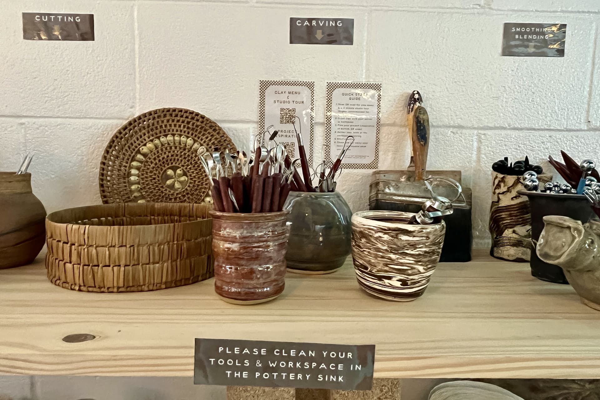 Pottery supplies and instructions are laid out on shelves toward the bar near the back of the venue. (Gabby Bailey/Community Impact)