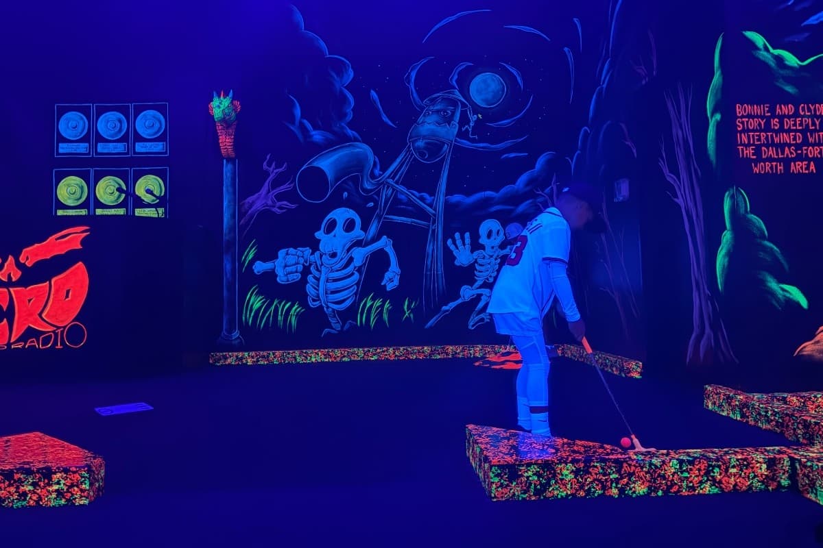 child playing mini golf