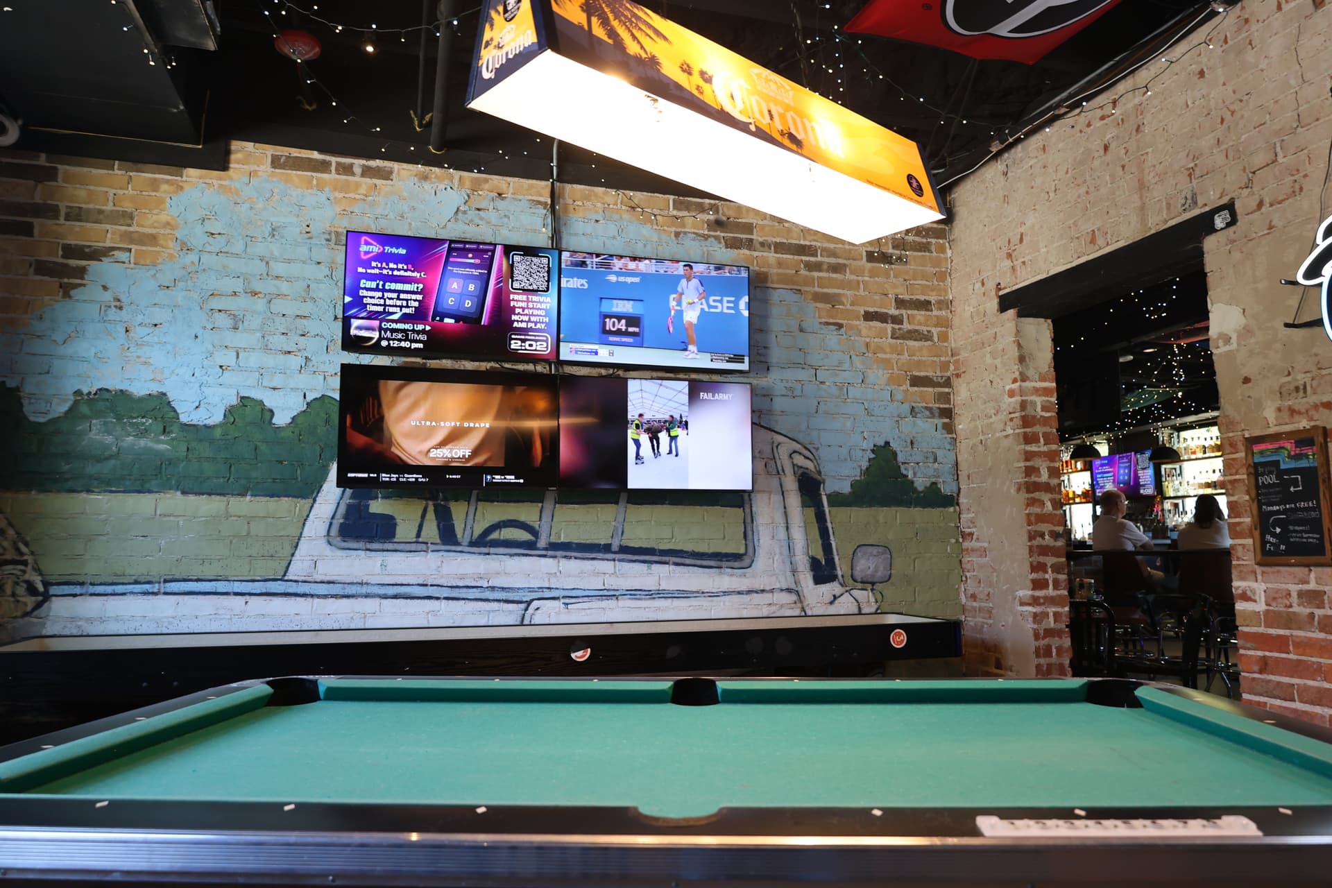 Nowhere Bar was designed as a blend of a favorite college bar and a warm dive bar, incorporating pool tables, multiple TV's, a shuffleboard and patio to create a welcoming experience for everyone. (Jack Hintze/Community Impact)