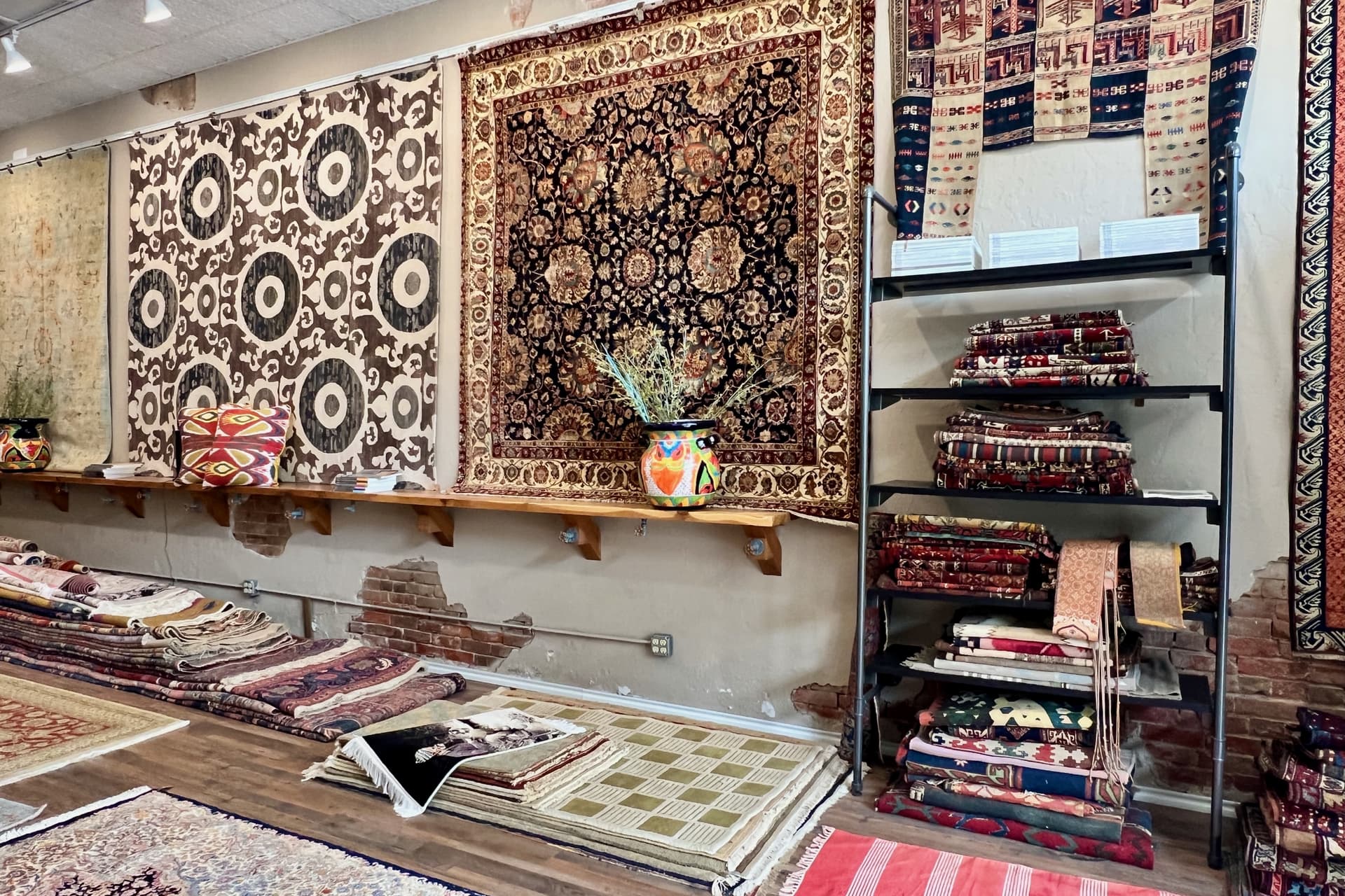 Rugs on a wall and a shelf