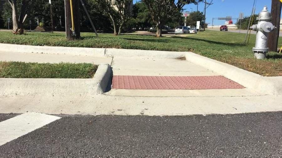 Sidewalk ramps being installed at Emerald Forest, William Cannon intersection