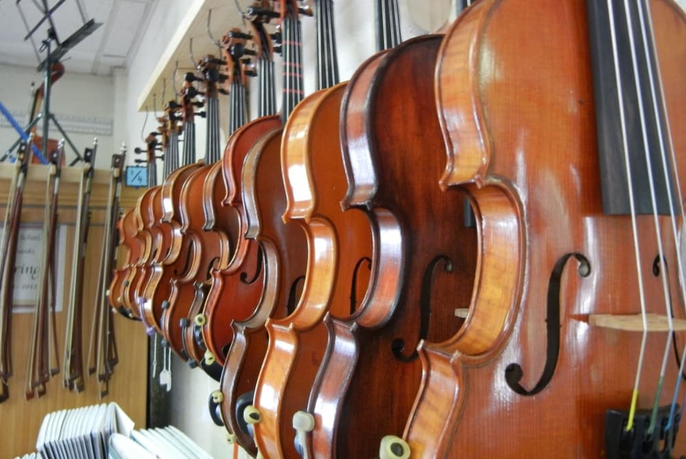 A wall of violins and violas are shown.