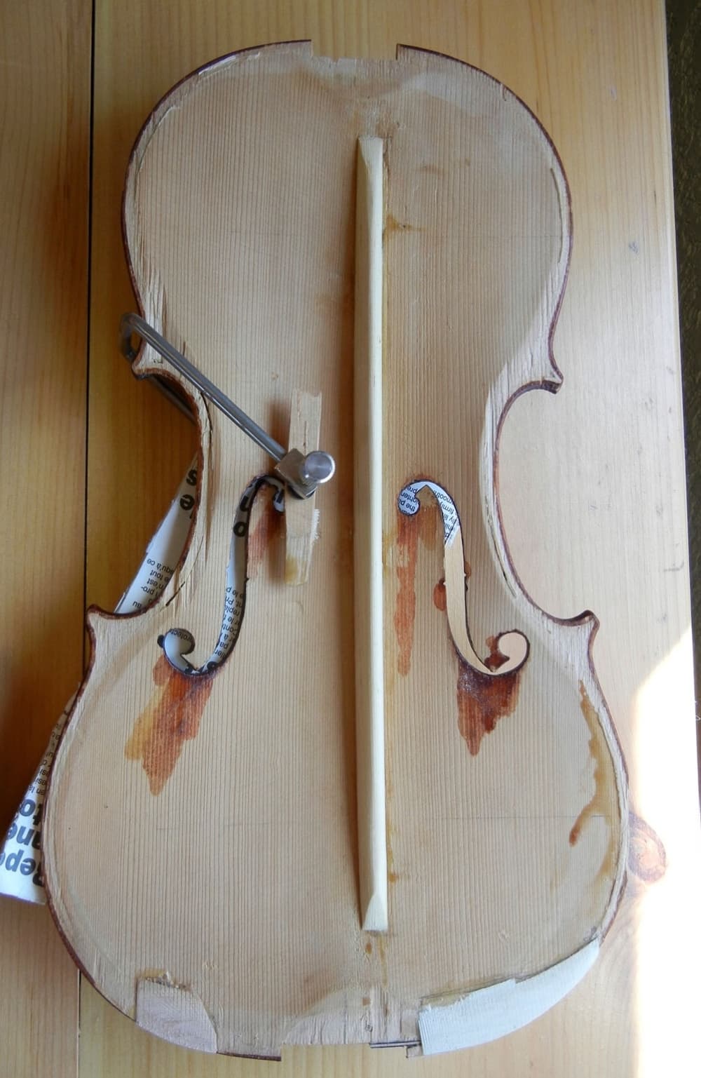 An open violin is shown waiting to be repaired.