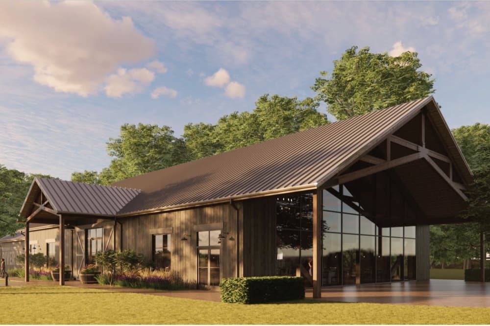 The wooden exterior is shown in shades of brown with large windows showing off the large trees.