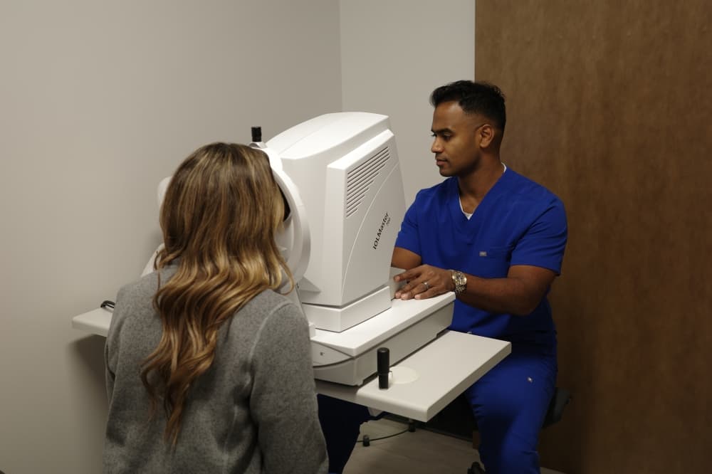 Dr. Vish Reddy examines a patient's eyes for cataracts and glaucoma and assesses for various treatment options.