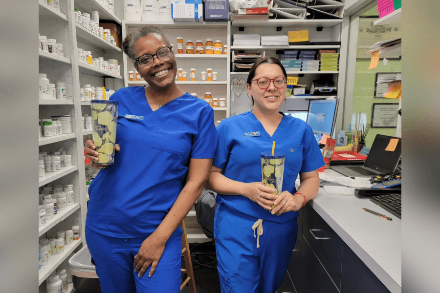 Staff at Compounding Shop Pharmacy in Fort Bend County standing in front of various medications they can compound.