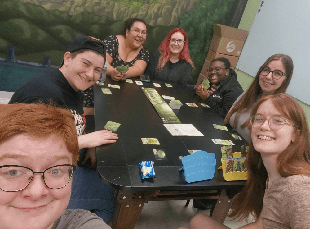 Group playing card games at The Adventure Begins, Conroe’s go-to shop for gaming and collectibles.