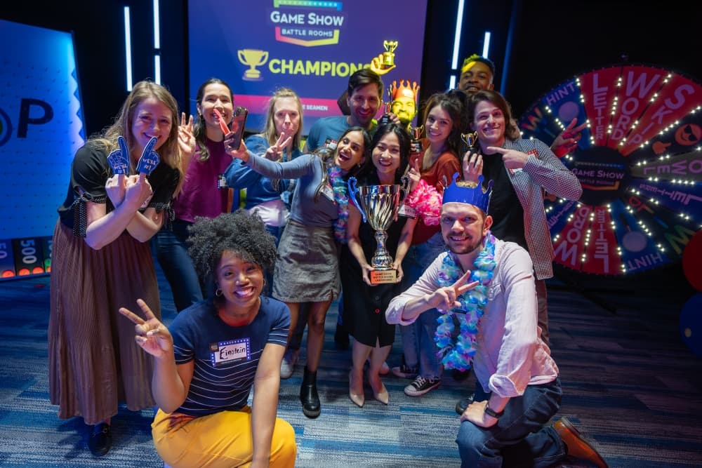 Corporate team-building group enjoying private game show experience with fun, fast-paced challenges and laughs.