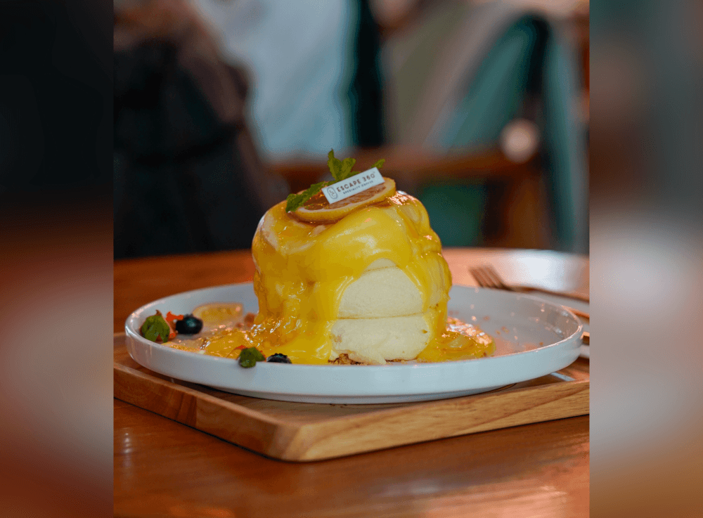 Lemon Curd Soufflé at Escape 360 Cafe in McKinney, a light and fluffy dessert topped with zesty lemon curd, crafted in-house for a sweet and tangy globally inspired treat.