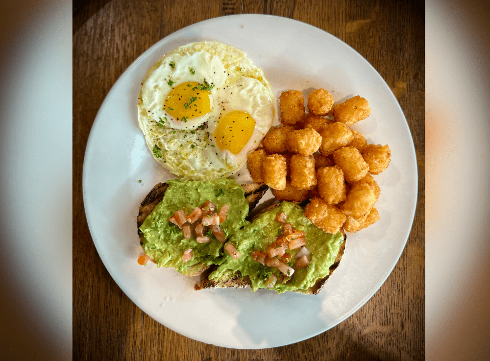Fresh avocado toast topped with seasonings and microgreens, served for Sunday brunch at Uncork’d Wine Bar & Grill in McKinney.