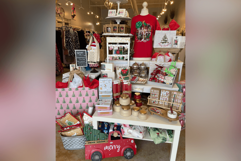 Holiday display at Adelyne’s Boutique & Gifts showcasing Christmas ornaments, custom laser-engraved presents, and festive seasonal home décor.