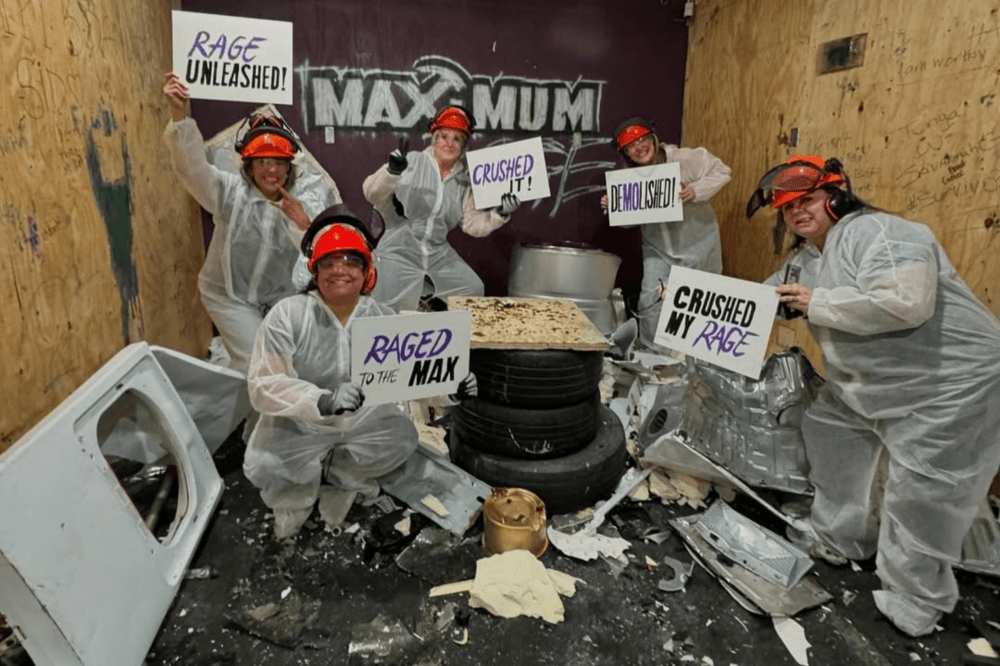A group enjoying team-building activities and stress-relief sessions at Maximum Rage, Humble’s premier entertainment destination featuring rage rooms, paint rooms, and customizable experiences for birthdays and bachelor parties.