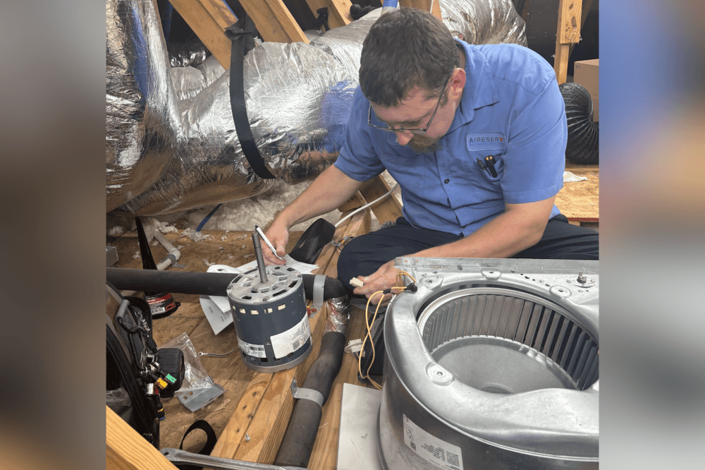 Aire Serv of Houston Northwest team installing a high-efficiency heating and cooling unit with 10-year parts and labor warranty.