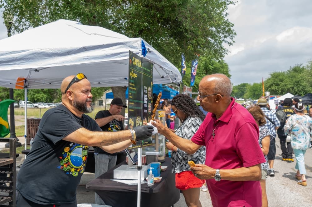 person getting food from food vendor