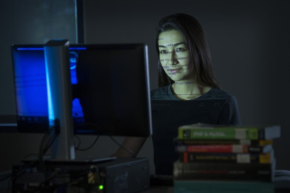 student typing on computer