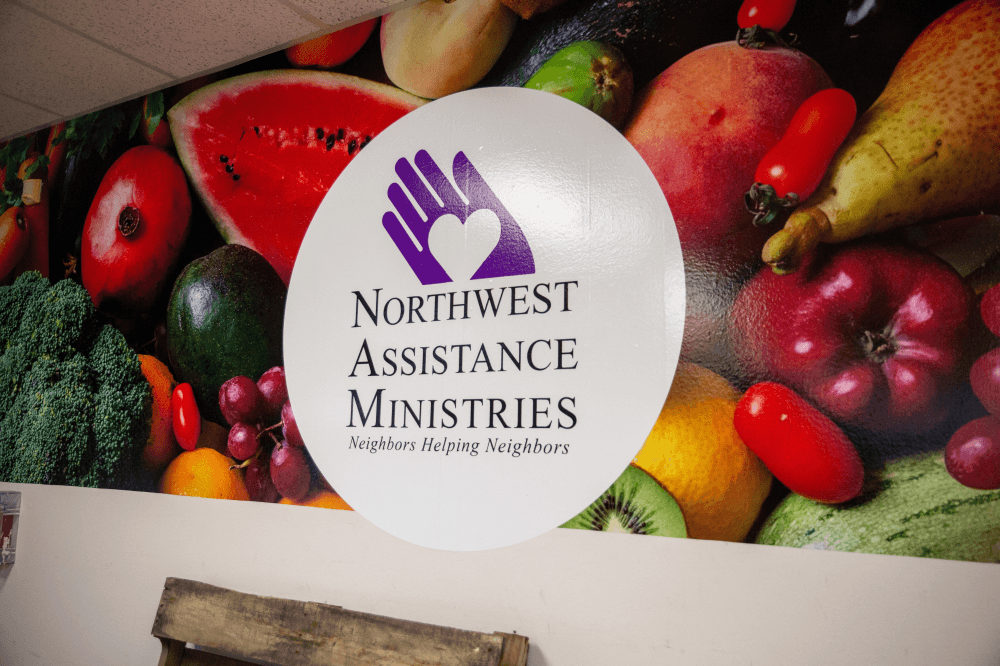 NAM logo painted on a wall with fruit on it