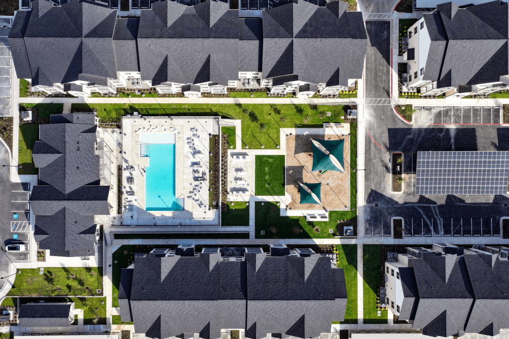 Aerial view of Preserve at Mustang Creek’s modern apartment buildings and landscaped grounds in Round Rock, Williamson County.