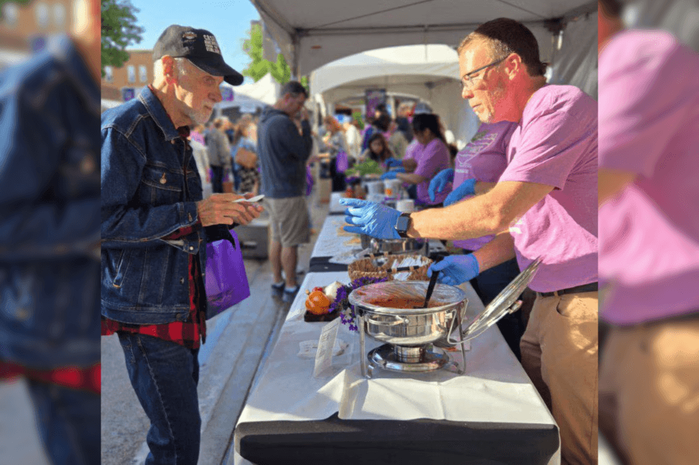 chef serving soup to man