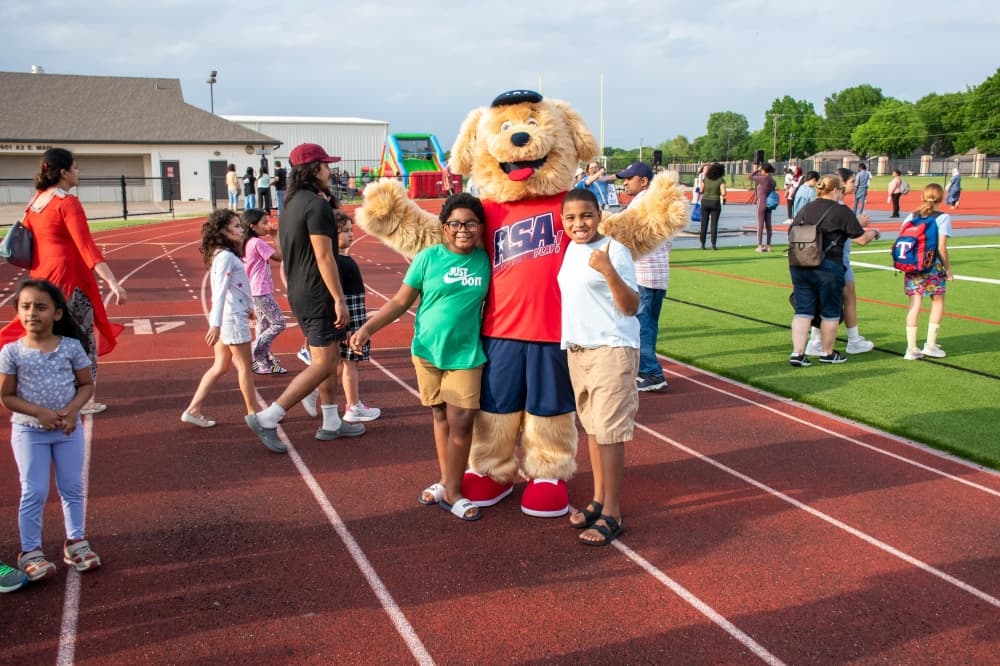 allen isd mascot posing with students