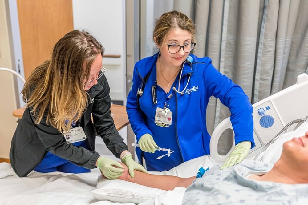 nurse and student treat patient