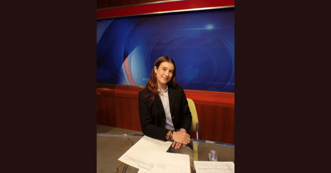 Woman in dark blazer sits at a news anchor desk with East Texas News graphics behind her.