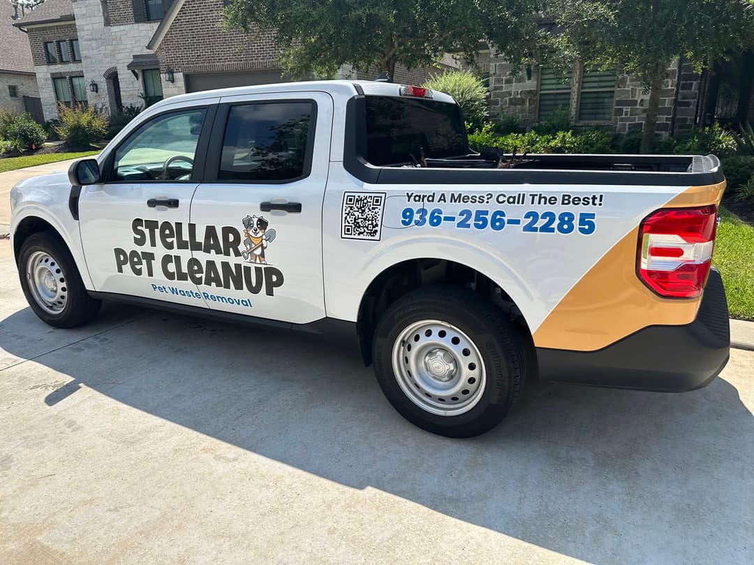 White Stellar Pet Cleanup pickup truck with logo and phone number 936-256-2285, parked in a driveway.